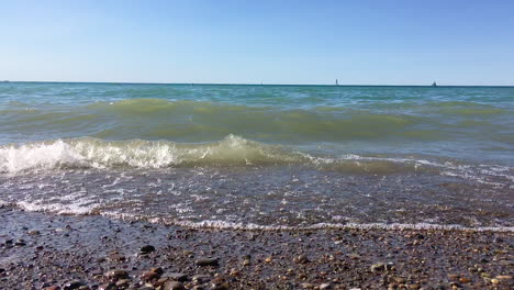 waves crashing on lake beach in slow motion