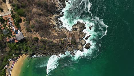 Aerial-view-above-the-rocky-coast-of-Puerto-Escondido,-Mexico---cenital,-drone-shot