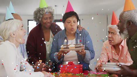 confetti animation over diverse group celebrating birthday with cake and candles