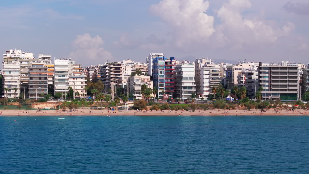 Tight aerial slider shot along Athens beach promenade