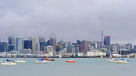 timelpase of auckland city, a mist covering the skytower, new zealand