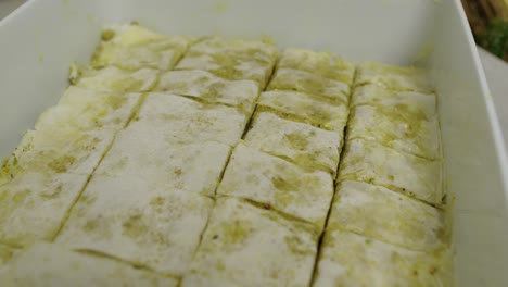 close up on cut baklava slices inside cooking ceramic tray