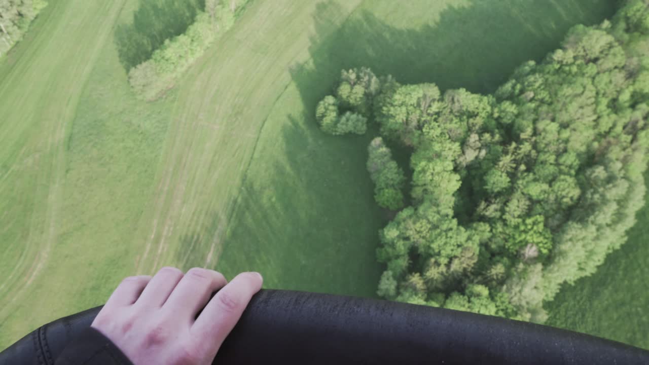 Close-up of hand holding wicker basket of hot air balloon during first flight, cinematic shot of emotions in the sky