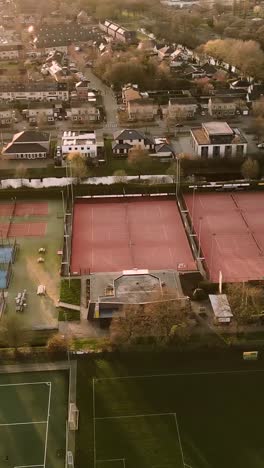 aerial view of tennis courts and residential area