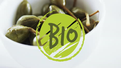 animation of bio text over capers in bowl on table