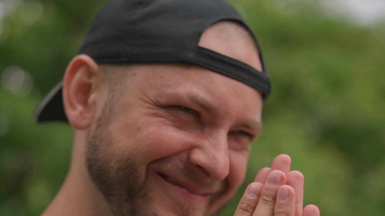 White Man Outdoors Grateful Smiling Eyes Closed, Thankful Passerby Praying With Clasped Hands, Peaceful Park Setting, Soft Sunlight, Serene Expression, Gentle Bokeh, Relief And Contentment, Mindful