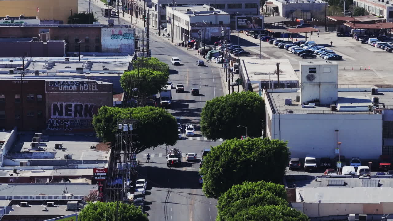 Aerial view of an urban street with traffic and buildings