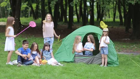 Family with Children Having Picnic in Nature Enjoying Sunset Family with Children Having Picnic in the Nature Enjoying Sunset Parents Dacing in front of Children