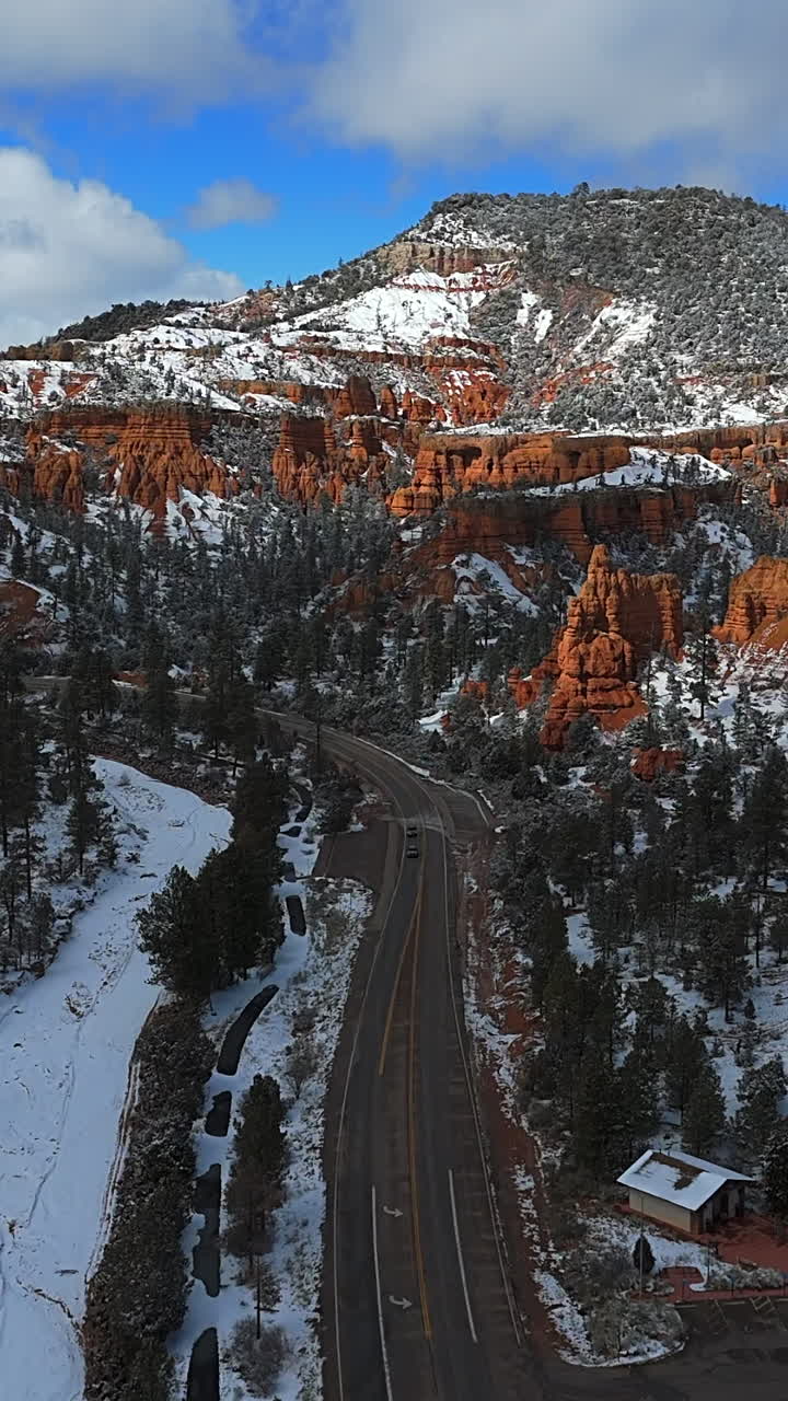 Vertical View Of Cars Driving On The Highway Driving Through The Bryce Canyon National Park In Utah, USA. - aerial shot