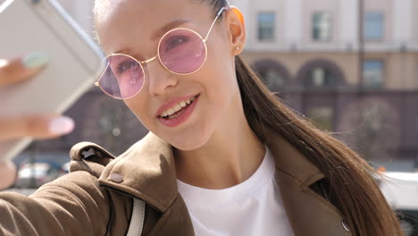 young woman taking a selfie in the city