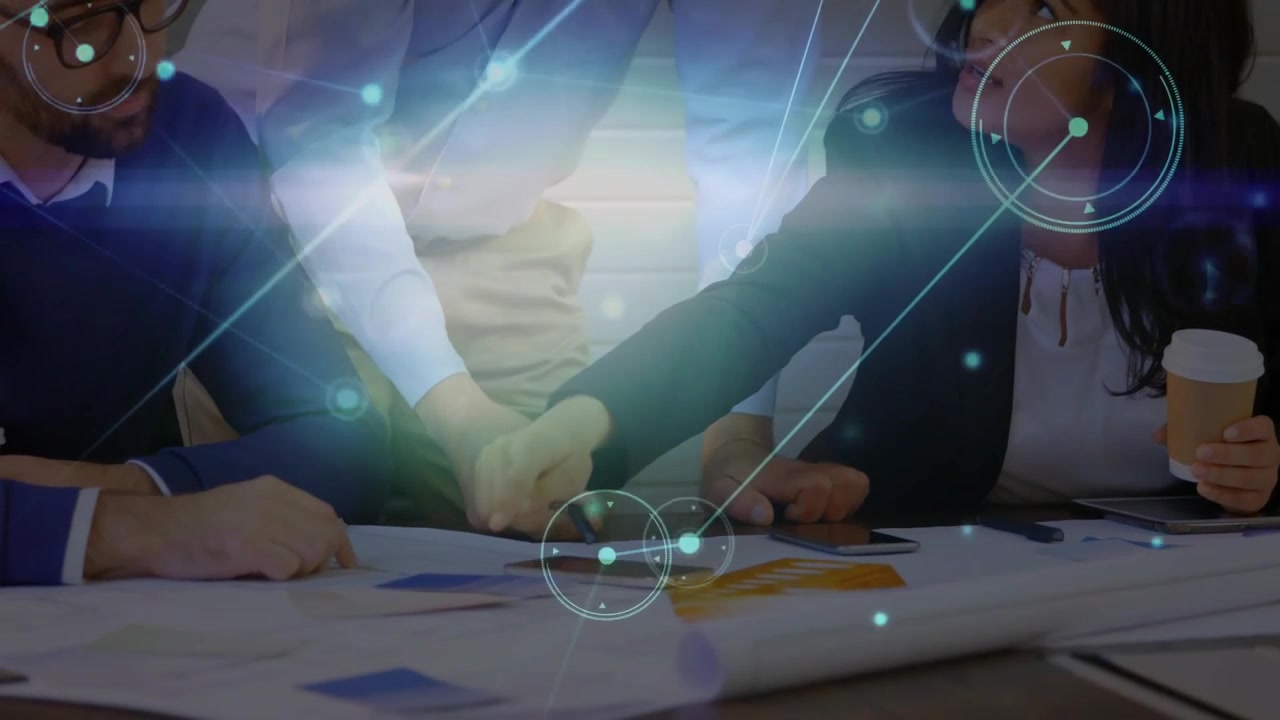 Team focusing on business blueprint pointing stacking hands confirming plan with overlay over hands