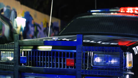 Close-Up-Of-The-Police-Car-With-Lights-From-The-Side-At-Night