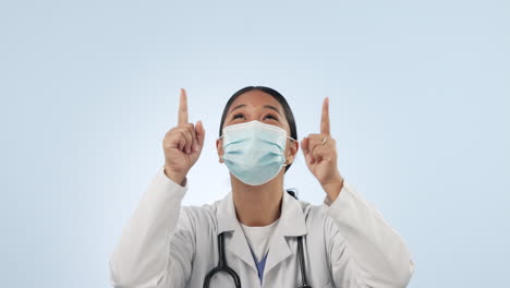 Studio-woman,-face-mask-and-doctor-pointing-up