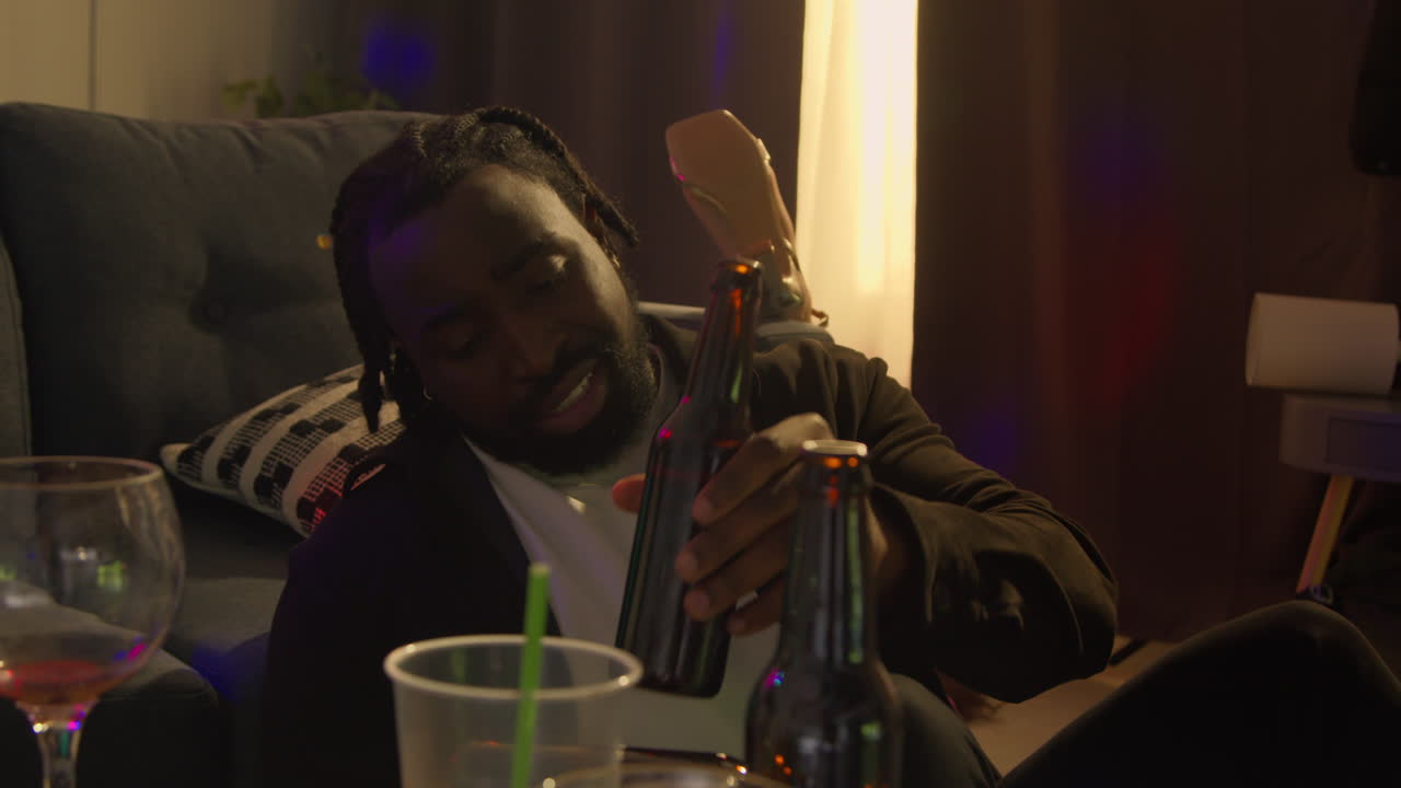 Man Sitting By Sofa At House Party Deciding He Has Had Enough Alcohol To Drink 1