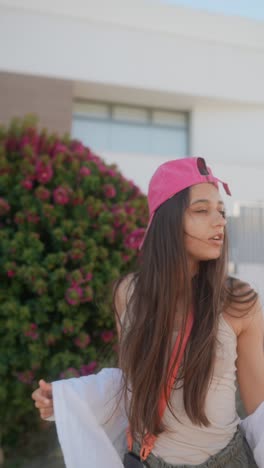 young woman in a pink baseball cap