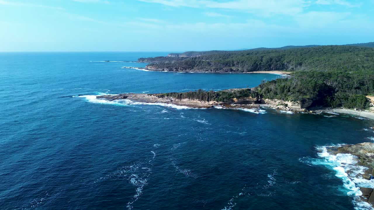 Drone aerial landscape South Durras Wasp head ocean coastline with waves breaking in bay cove and bushland trees Australia hiking trails Shoalhaven nature suburbs