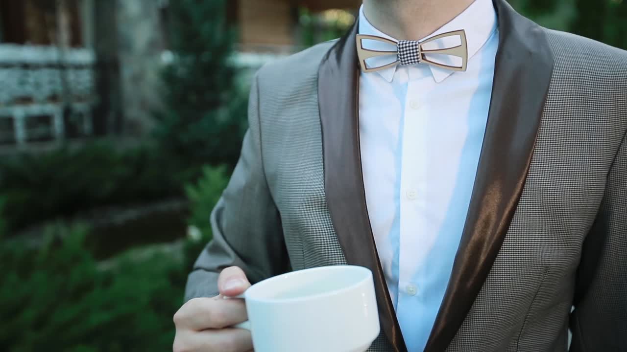 Man With Tea Cup Outdoors. Handsome young man drinking coffee outdoors