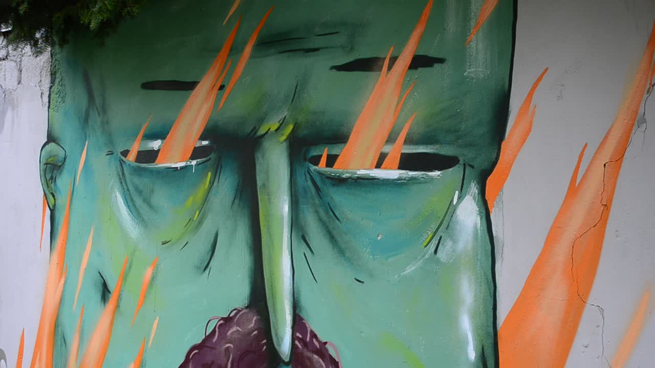 The artist draws graffiti on a fence, Kozak's drawing