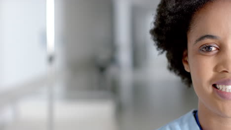 African-American-nurse-smiles-warmly-in-a-bright-hospital-corridor-with-copy-space