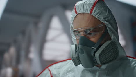 professional chemist analyzing flask with liquid in uniform laboratory close up.