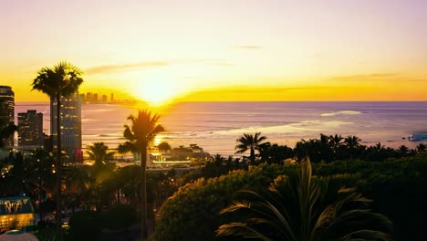 sunset casts a warm glow over a city skyline, blending urban architecture with the tranquil beach and ocean nearby