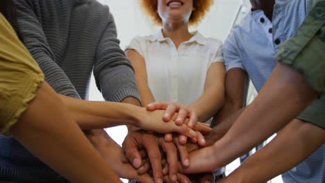 Team of business people forming hand stack