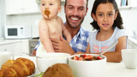 Portrait-of-family-behind-breakfast-table-