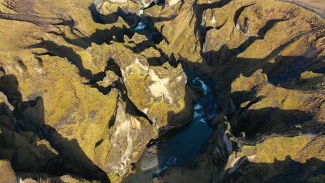 fjaðrárgljúfur canyon in southern iceland, rotating drone, sunny afternoon