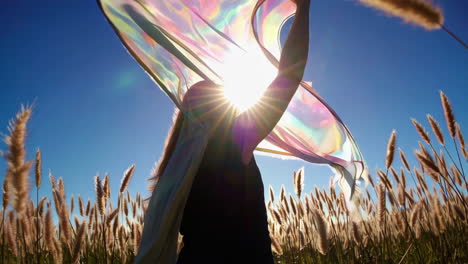 woman in a field with a colorful scarf
