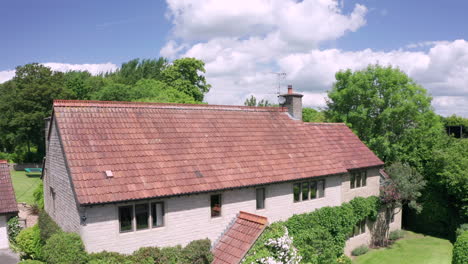 rising aerial shot of a large family home revealing rural surroundings