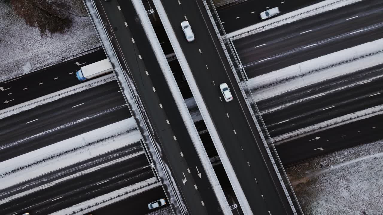 Drone rises over snowy highway traffic showing global trade and climate risk