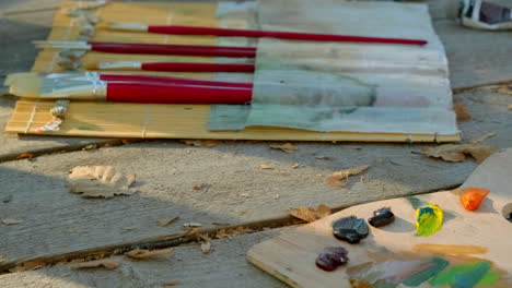 artist's workspace with paint palette and brushes