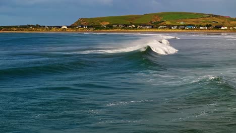 Wave-breaks-with-mist-spraying-off-top-picked-up-by-wind-making-rainbows