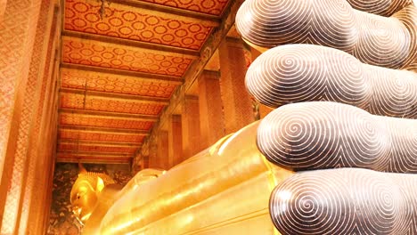 golden buddha statue with intricate ceiling details