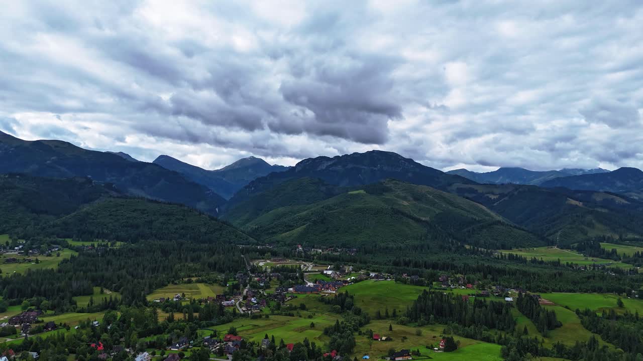 Timelapse of mountain peaks near Zakopane, Poland, during summer. Dramatic clouds drift over lush alpine landscape. Perfect for nature, travel, and cinematic outdoor visuals