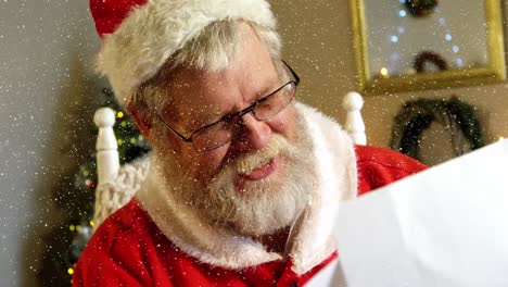 composición de video con nieve cayendo sobre cámara lenta santa leyendo cartas