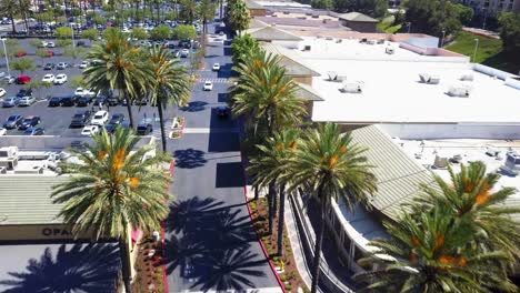 aerial fly through a shopping mall strip mall parking lot shot3