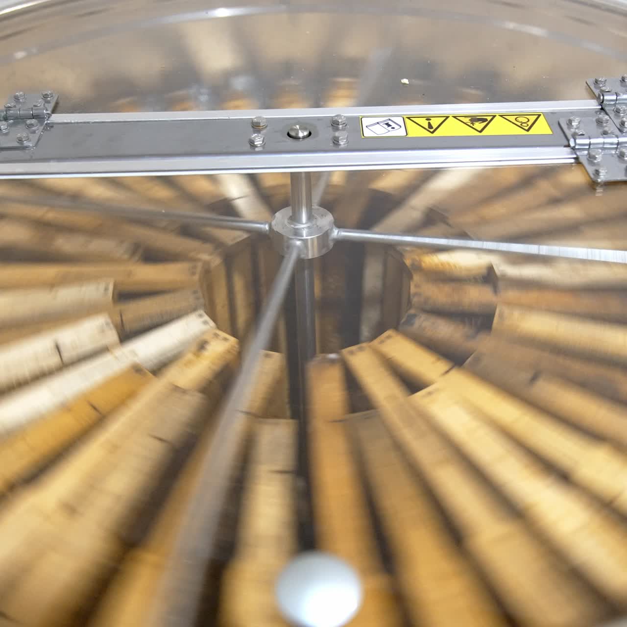 Centrifuge device rotating to pump the honey out of honeycombs. Special apiary equipment for harvesting honey