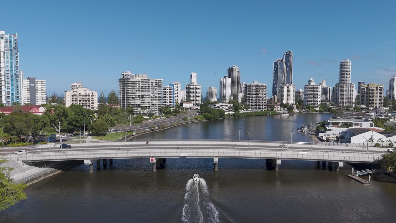 Speedboat travels under bridge in urban setting
