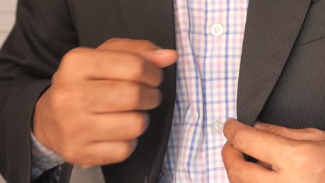 man adjusting his suit jacket