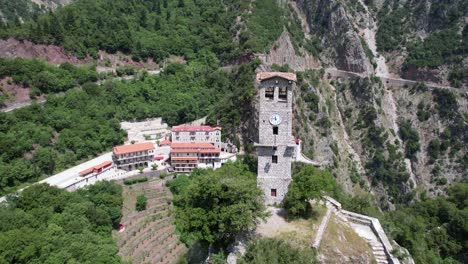 proussos monastery in evrytania greece, aerial point of interest shot with clock tower in foreground