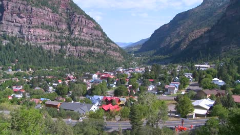 a downtown establishing shot of ouray colorado with steam train passing