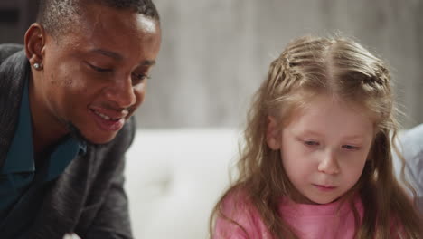 african-american teacher helps girl do english homework