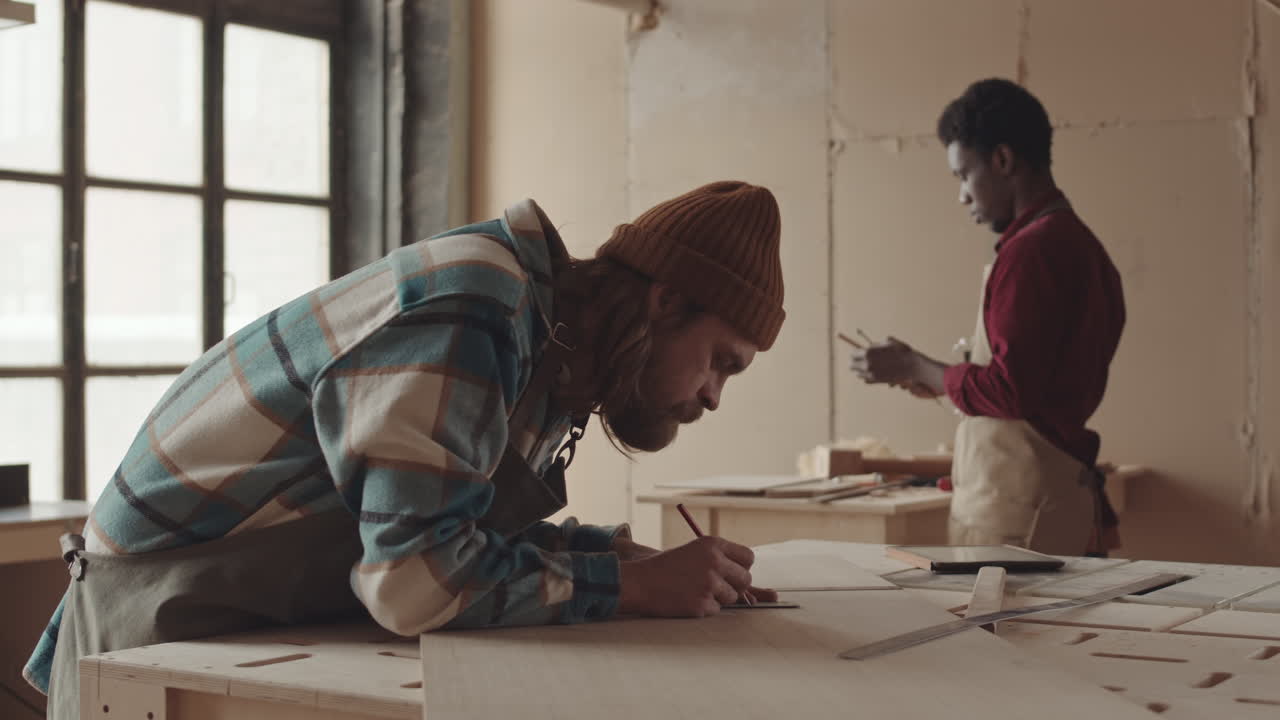 Two Multiethnic Joiners Working in Workshop
