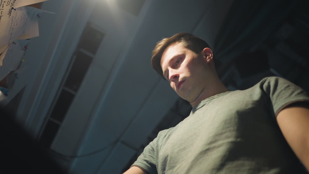 Person focusing on adjusting equipment, working with digital control panel, manipulating sliders and settings in professional studio, performing hands-on task in technical environment