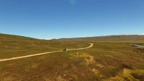 Toyota-Land-Cruiser-Jeep-driving-on-dirt-road,-Deosai-Plains,-Pakistan