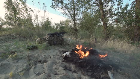 soldier resting by a campfire in the forest