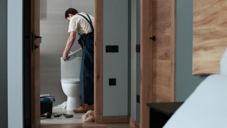 plumber fixing toilet