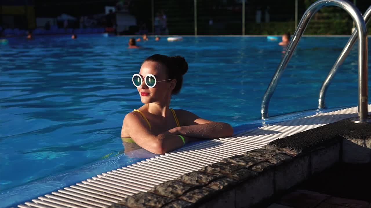 Woman Relaxing by Pool in Sunglasses