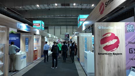 people dealing and walking at reseller park at ifa berlin 2024, this area is to make deals. walking shot stabilized.